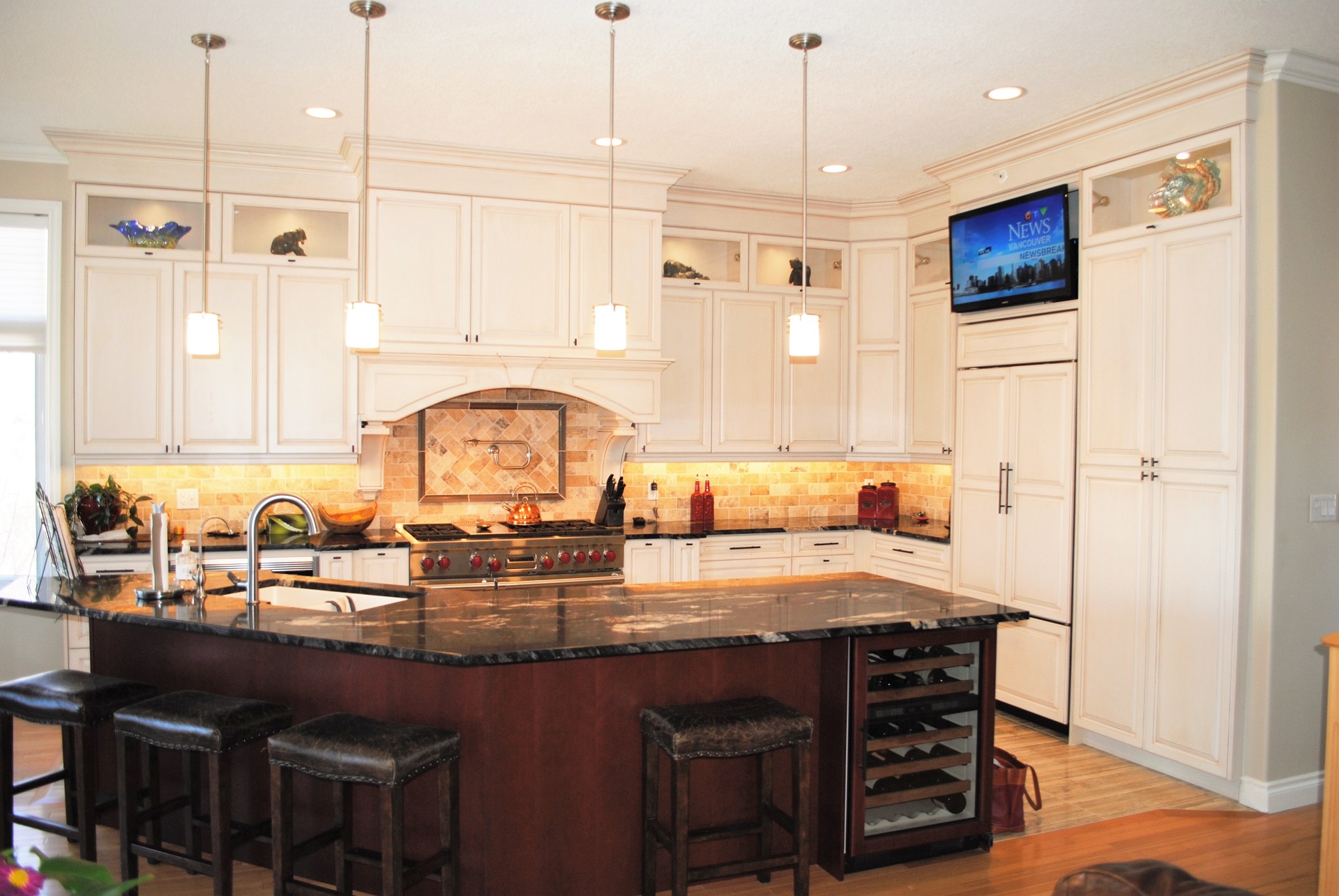 A kitchen renovation featuring a wine installation by Refine Renovations